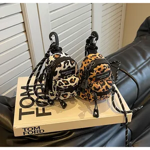 Detailed view of mini leopard print crossbody bags with zipper pockets and top hooks