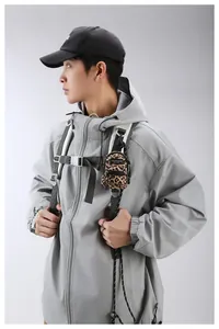 Mini leopard print crossbody bag charm showing practical use on a backpack strap