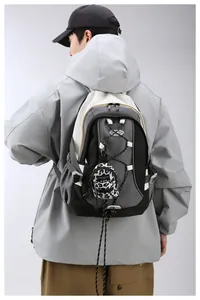 Rear view of grey and white crossbody bag with leopard print mini pouch on a male model