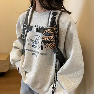 Mini leopard print backpack charm on a grey hoodie, stylish accessory for outdoor travel