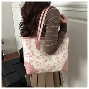 Detail shot of the graffiti-style pattern and text on the pink and white tote bag