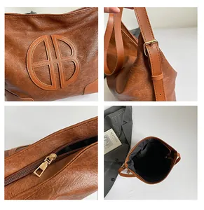 Gros plan détaillé du sac cabas vintage marron montrant la boucle dorée et le rangement