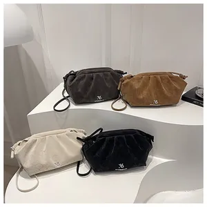 Quilted cloud crossbody bags in grey, brown, white, and black with suede finish texture