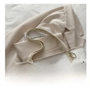 Detail of white tote bag with silver star pattern, mini pouch and cloud plush charm