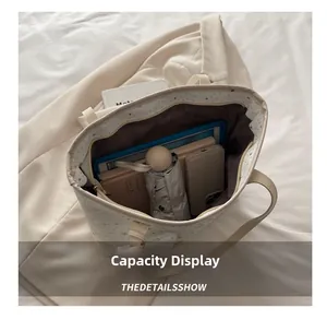 Capacity display of large star pattern tote bag holding tablet, umbrella and phone