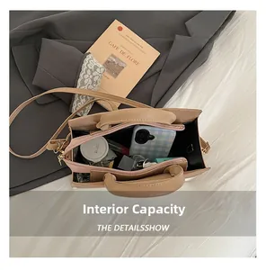 Top view of spacious interior of khaki crossbody bag showing phone and lipstick