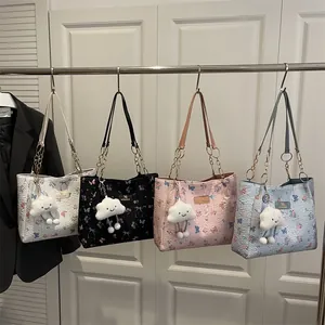 Women's butterfly tote bag with floral embossing, gold chain, and plush cloud charm