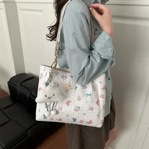 Floral butterfly tote bag with chain strap and cloud charm shown on model
