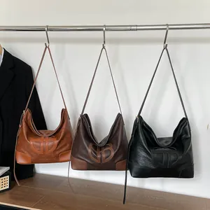 Grand sac hobo vintage en cuir marron et noir avec logo embossé élégant