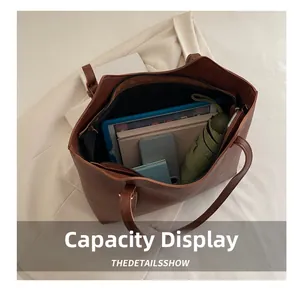 Brown tote bag interior showing large capacity for tablet, umbrella and daily essentials