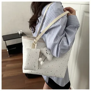 Detailed view of large white tote bag with silver stars and fluffy cloud charm