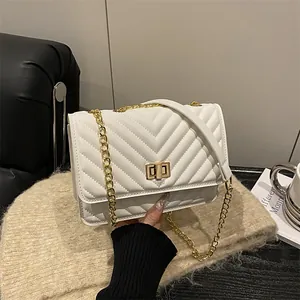 Sac à bandoulière matelassé blanc avec fermoir tournant doré et sangle en cuir