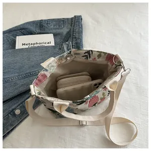 Detail view of canvas tote interior with strawberry embroidery and magnetic closure