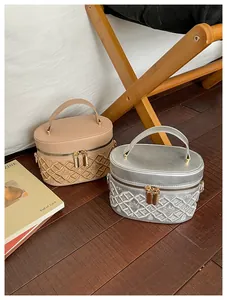 Detailed close-up of quilted PU leather makeup bag with crown embroidery and gold zippers