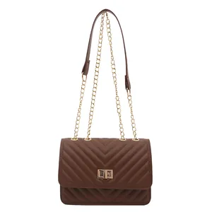 Brown V-quilted faux leather crossbody bag with gold turn-lock and chain strap