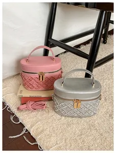 Detail of vintage box vanity bags in pink and silver with crown diamond embroidery