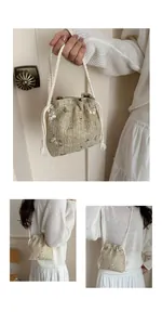 Close-up of woven straw bucket bag featuring pink flower embroidery and drawstring detail
