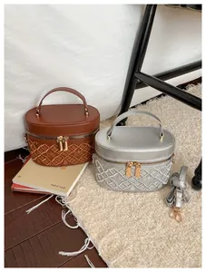 Top view of brown and silver embroidered bucket bags with adjustable shoulder straps