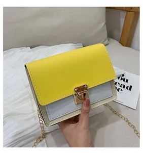 Close-up of tricolor crossbody bag featuring yellow, blue, and cream leather with gold lock