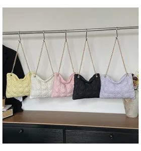 Detailed display of colorful quilted shoulder bags with elegant gold chain straps