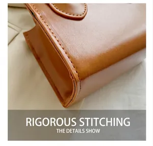 Detail showing high-quality stitching and rich leather texture on brown crossbody bag