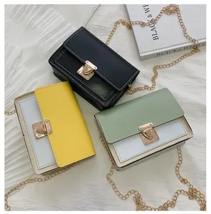 Three leather crossbody bags with golden triangle locks and chain straps on fabric