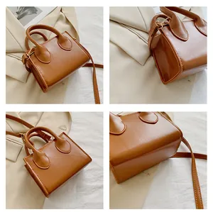 Multiple views showing matte brown leather texture and gold hardware of small square bag