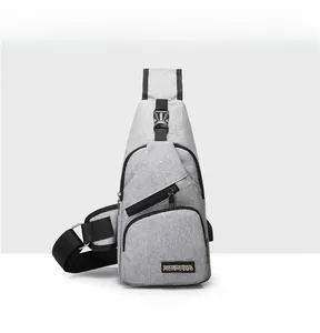 Detailed front view of gray oxford fabric men's sling bag with multiple zip pockets