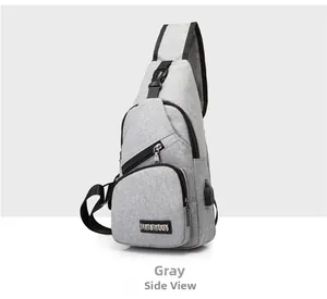 Close-up of gray Oxford chest bag showing multiple zippers and integrated USB charging port