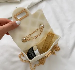 Internal view of mini pearl chain bag showing space for lipstick and cosmetics