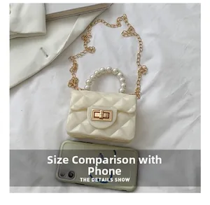 Mini pearl handle crossbody bag compared with mobile phone for size reference