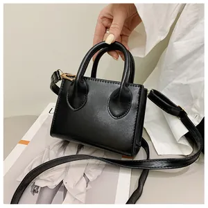 Minimalist black PU leather square handbag with golden hardware and detachable strap