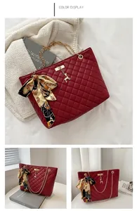 Detail of red quilted tote with gold chain strap, deer charm and decorative silk scarf