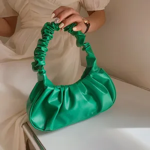 Detalle del bolso de nube verde esmeralda con asa fruncida y diseño plisado chic