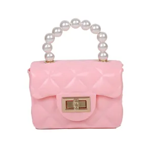 Pink mini crossbody bag with quilted texture and white pearl handle for women