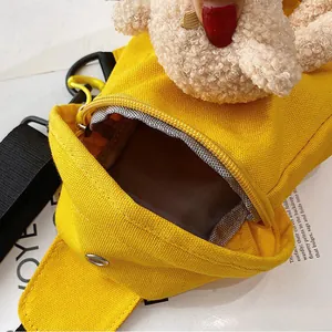 Trendy yellow canvas crossbody bag for women with cute teddy bear plush charm