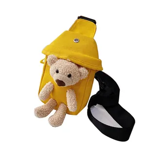 Yellow canvas crossbody bag for women with cute teddy bear plush decoration