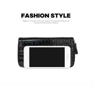 Detail view of long black stone texture wallet with tassel and smartphone size comparison