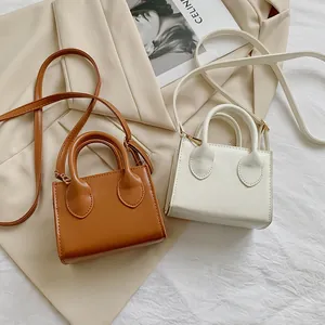 Minimalist mini square tote bags in brown and beige PU leather with crossbody straps
