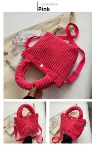 Detailed macro view of pink corduroy bucket bag texture with adjustable strap and button