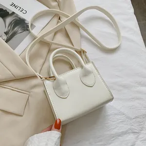 Chic cream white mini square handbag with top handles and adjustable shoulder strap