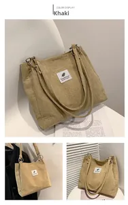 Detail of khaki corduroy tote bag showing textured fabric and stylish leaf emblem