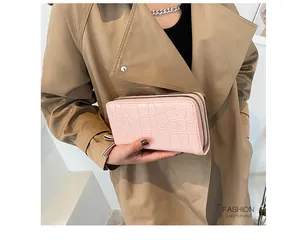 Close-up of pink stone pattern wallet with double zipper on khaki coat background