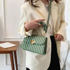 Chic mint green quilted crossbody bag with heart buckle and ruched handle