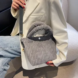 Gray corduroy bucket bag with pleated handle and adjustable shoulder strap for women