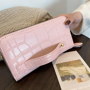 Pink crocodile embossed long wallet for women with double zipper and wrist strap
