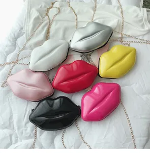 Flat lay of seven colorful lip-shaped mini crossbody bags with gold chain straps