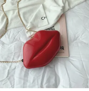 Glossy red lip-shaped crossbody bag with gold chain and zipper detail close-up