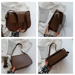 Detailed views of vintage brown saddle bag with matte leather and adjustable gold buckle