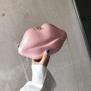 Pink lip-shaped mini crossbody bag with glossy finish and gold chain strap for women